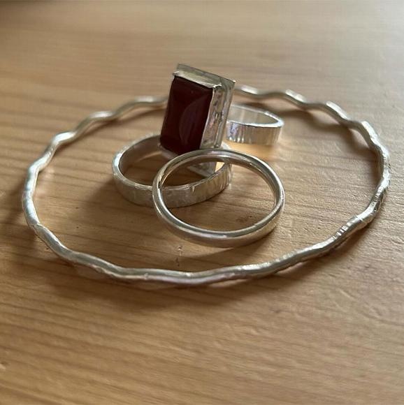 selection of silver jewellery, including rings and a bracelet